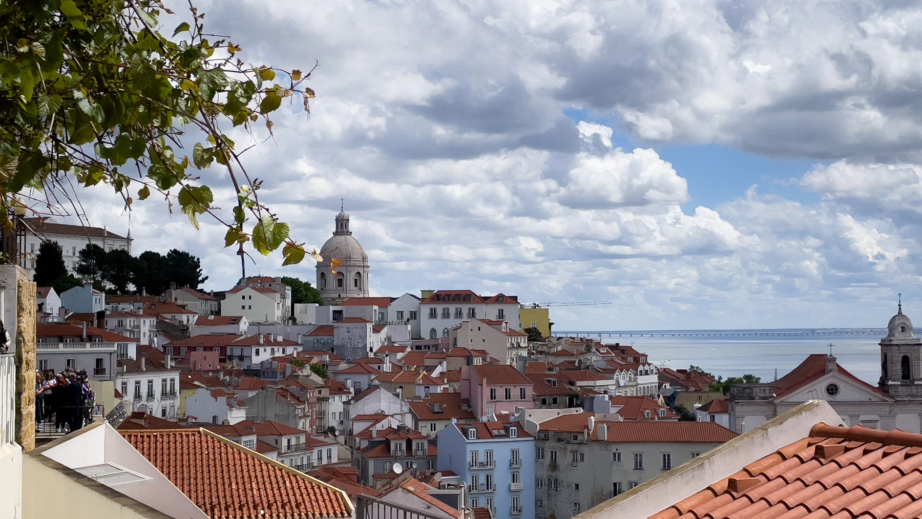 Lisbon cityscape with terracotta rooftops and the sea